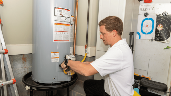 Plumber fixing a pipe under sink